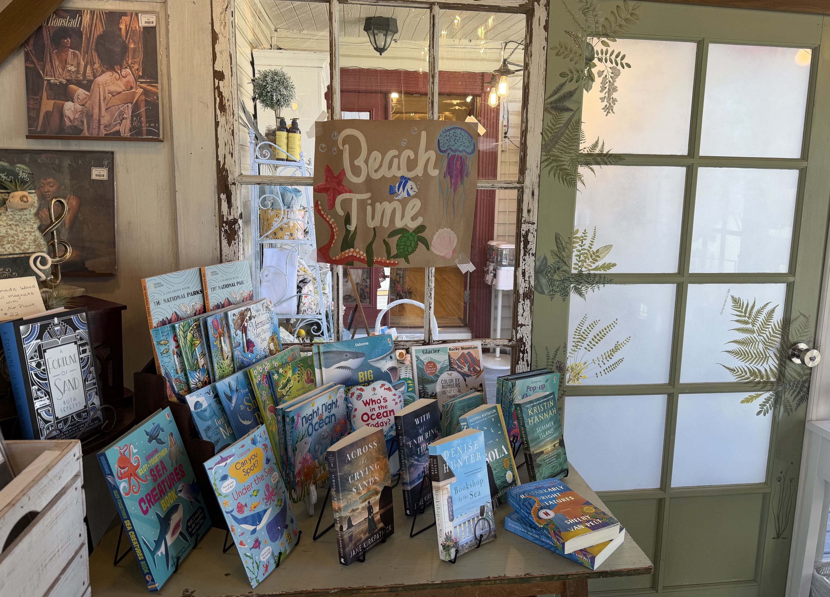 A seasonal beach-themed book and gift display near the shop windows