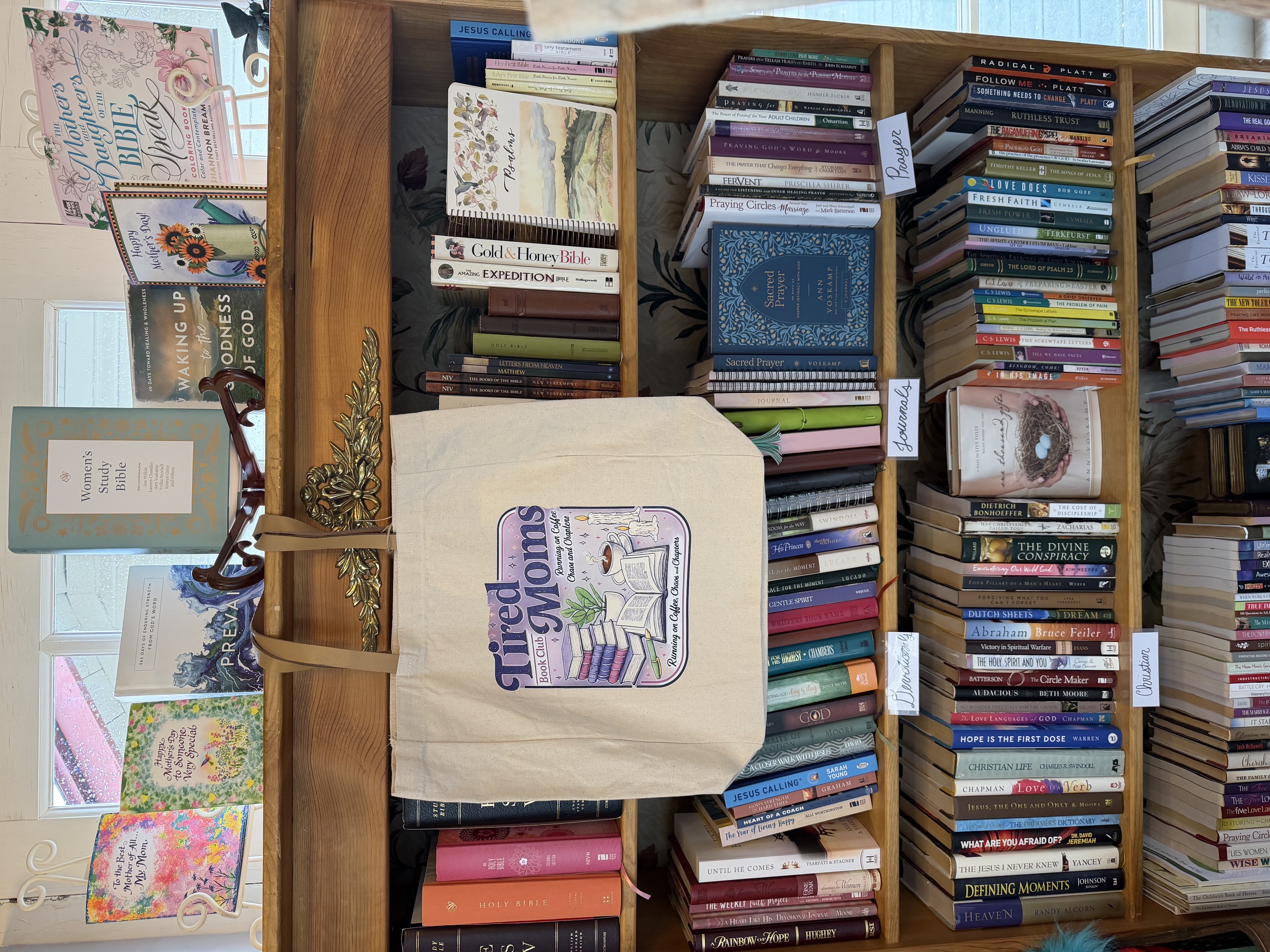 Wooden bookshelves filled with used and new titles inside the shop
