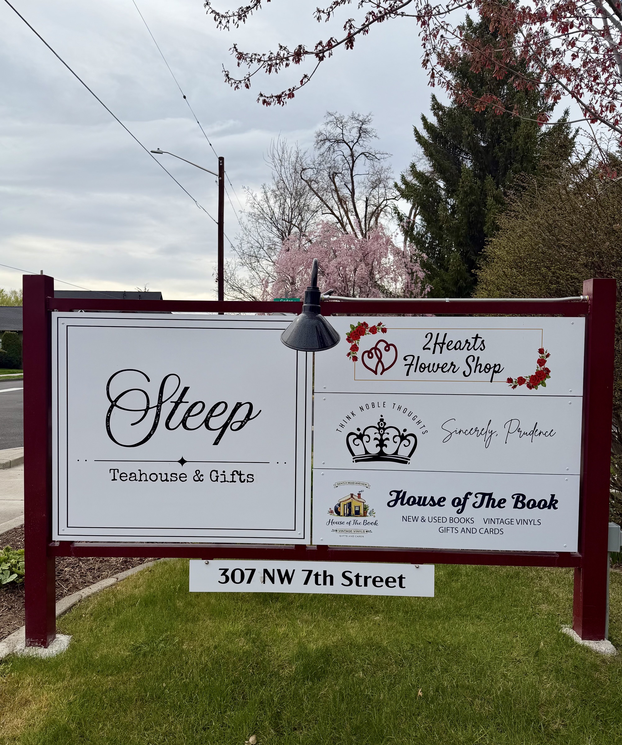 Street sign at 307 NW 7th Street showing House of the Book among neighboring shops