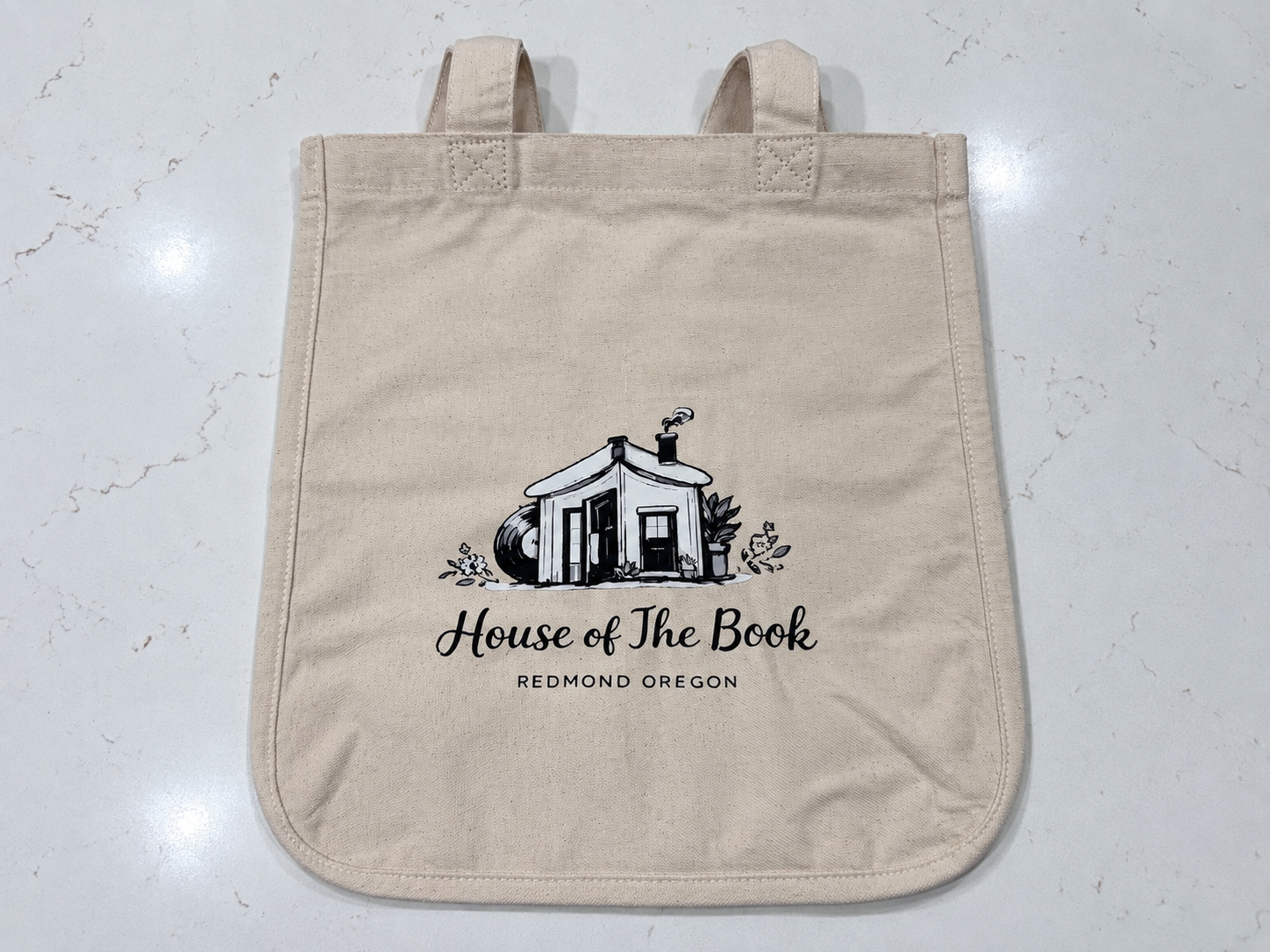 A House of the Book tote bag displayed in the shop